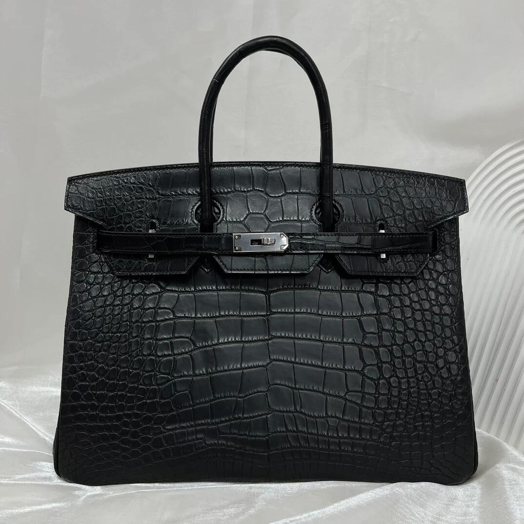 Black textured double-handle bag, front view