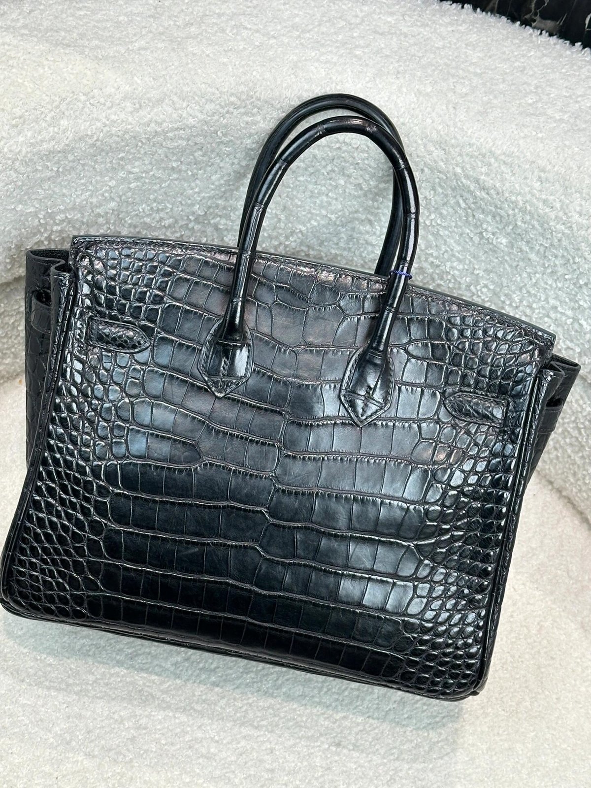 Black textured double-handle bag, photographed from the back