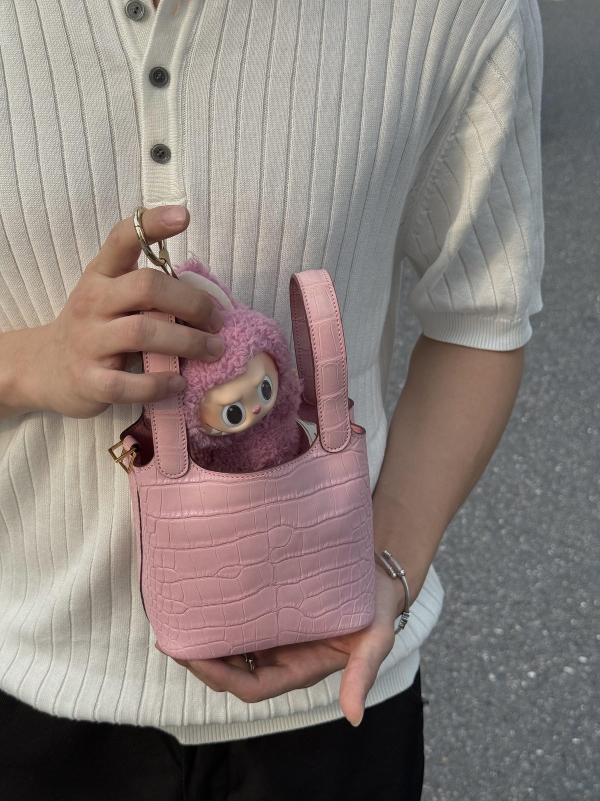 Small pink open basket bag with textured panels and short handles